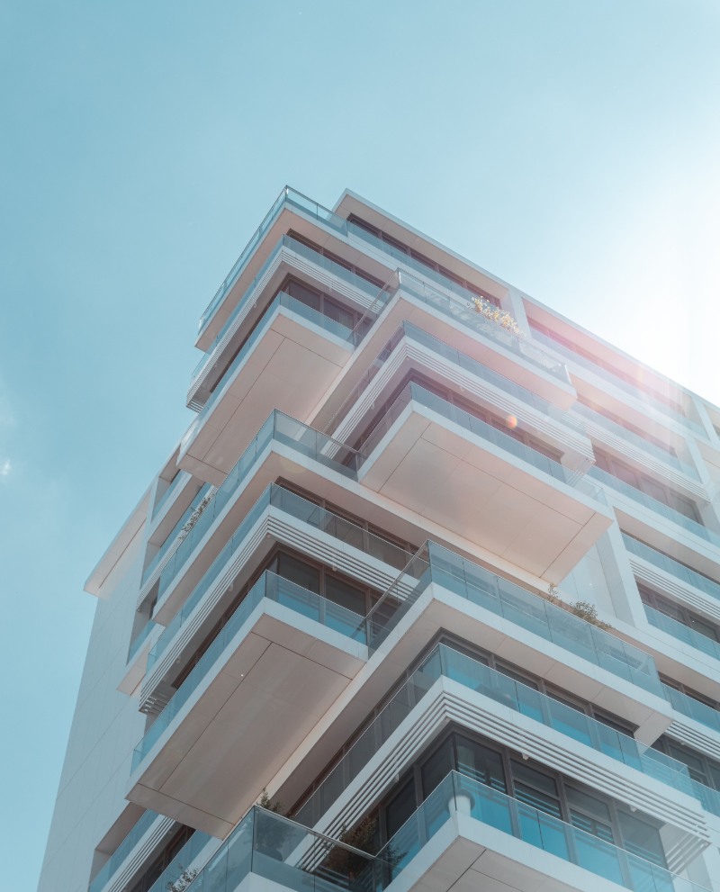 Residential tower seen from below against a clear sky